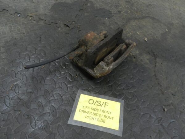 162. 1996 HONDA SMX. DRIVER SIDE FRONT BRAKE CALIPER + CARRIER